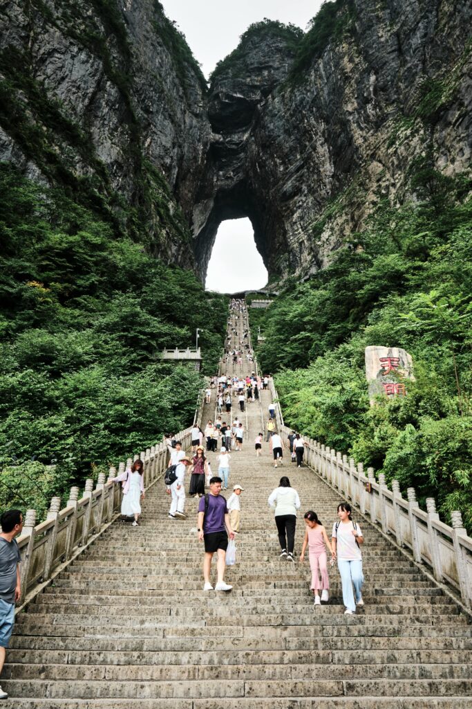 Visitors exploring the famous stairway leading to Tianmen Cave in Zhangjiajie, China.