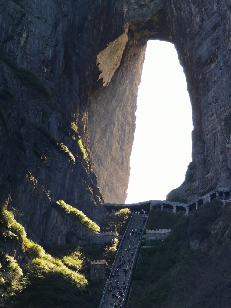 View of Tianmen Mountain's towering natural arch and staircase in China.
